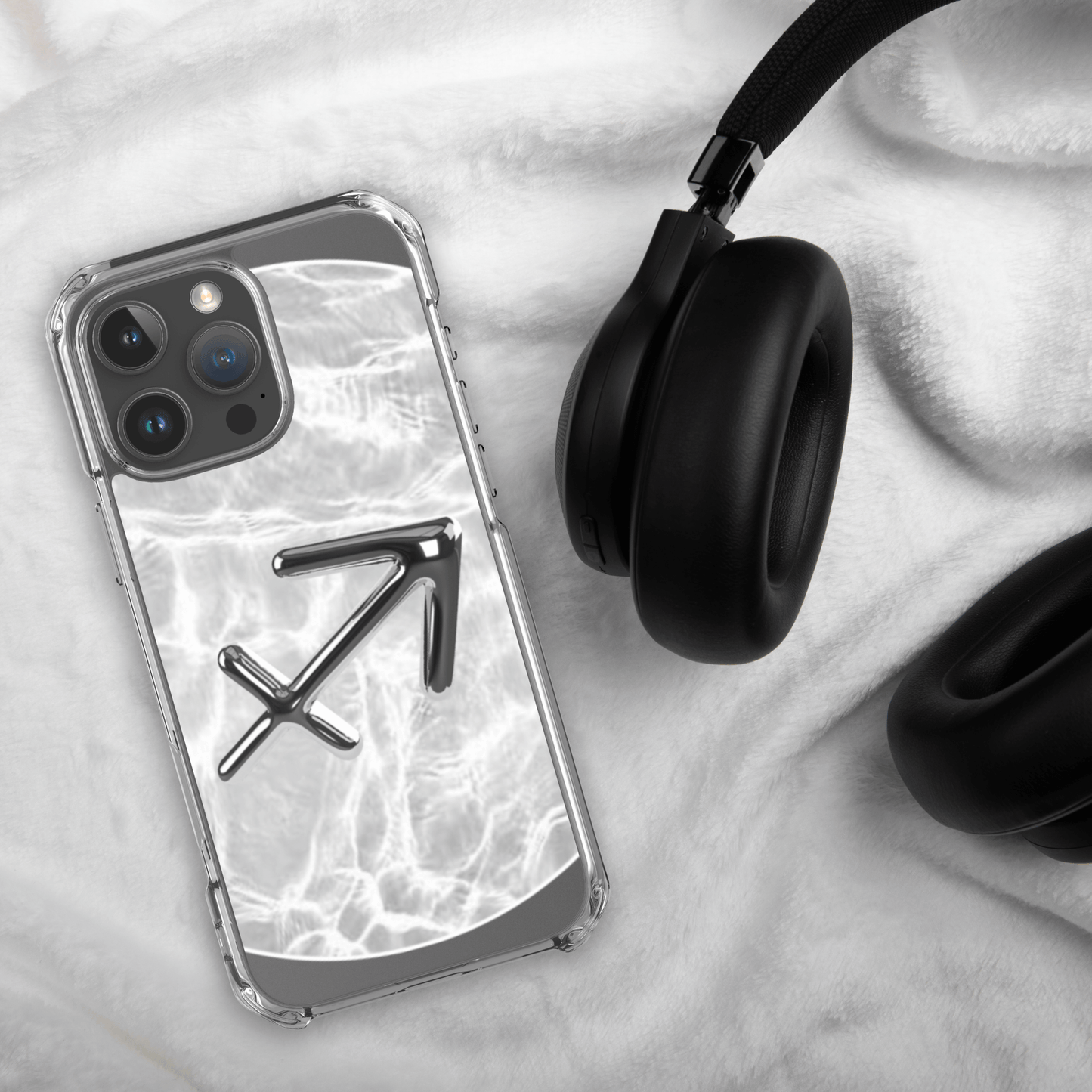 Zodiac Sagittarius Magsafe clear iPhone case with metallic design on marble background and headphones.
