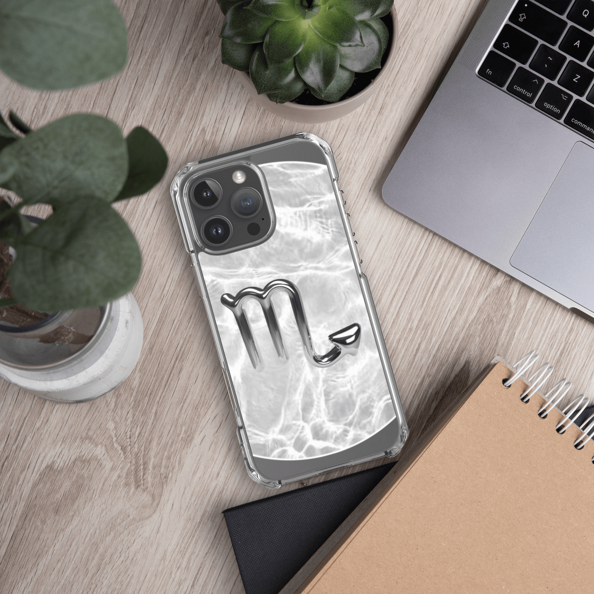 Zodiac Scorpio clear iPhone case with metallic design on a marble background, showcasing cosmic elegance.