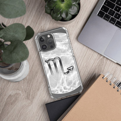Zodiac Scorpio clear iPhone case with metallic design on a marble background, showcasing cosmic elegance.