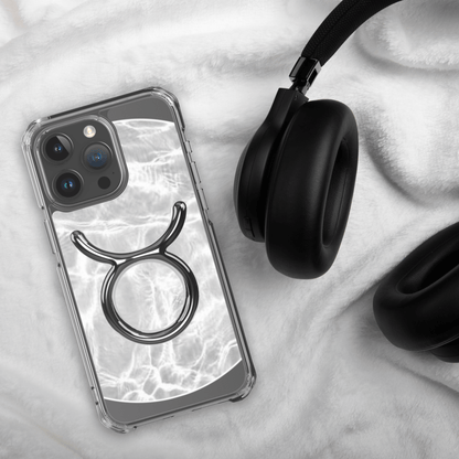 Zodiac Taurus MagSafe clear iPhone case with marble design, showcasing elegance and strength, next to black headphones.