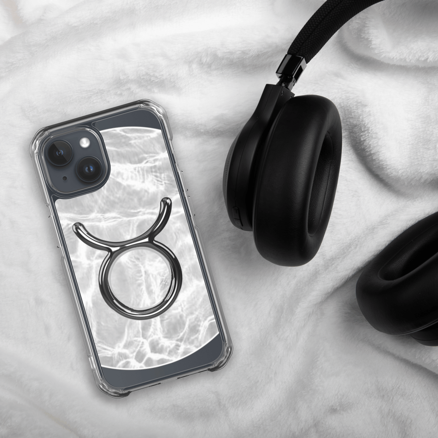 Zodiac Taurus MagSafe iPhone case on soft fabric with headphones, showcasing a marble metallic design.