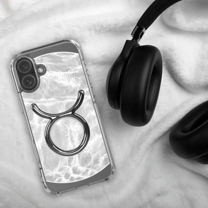 Zodiac Taurus Magsafe clear iPhone case with metallic design on marble background, styled with headphones.
